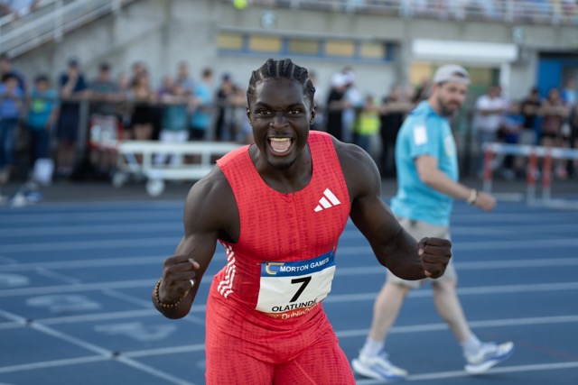 Athlete sprinting with crowd in background