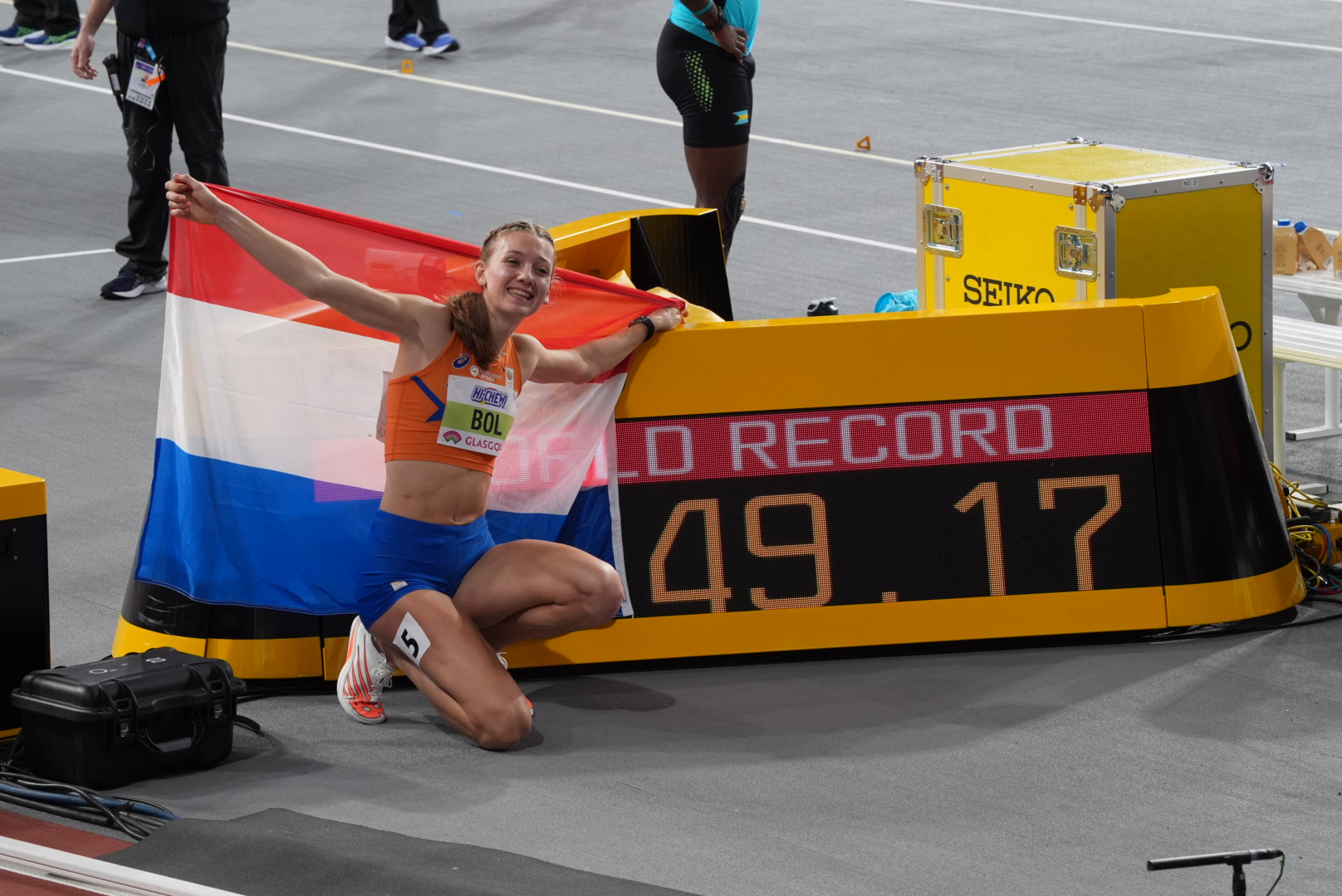 Runner crossing finish line with arms raised